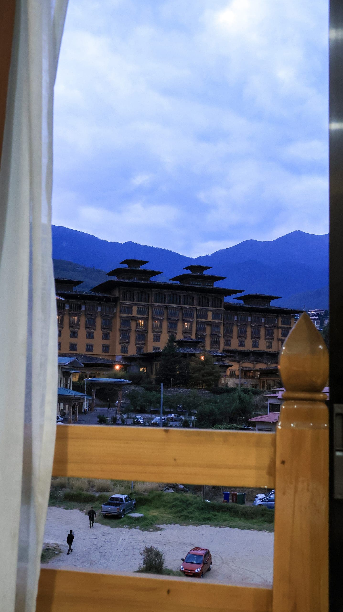 View from a hotel window across Thimphu towards Tashichho Dzong and the mountains